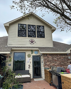 Texas home with black-framed windows and Texas star